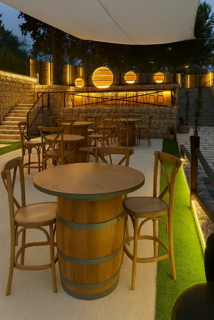 Tall outdoor bar tables standing on barrel bases.